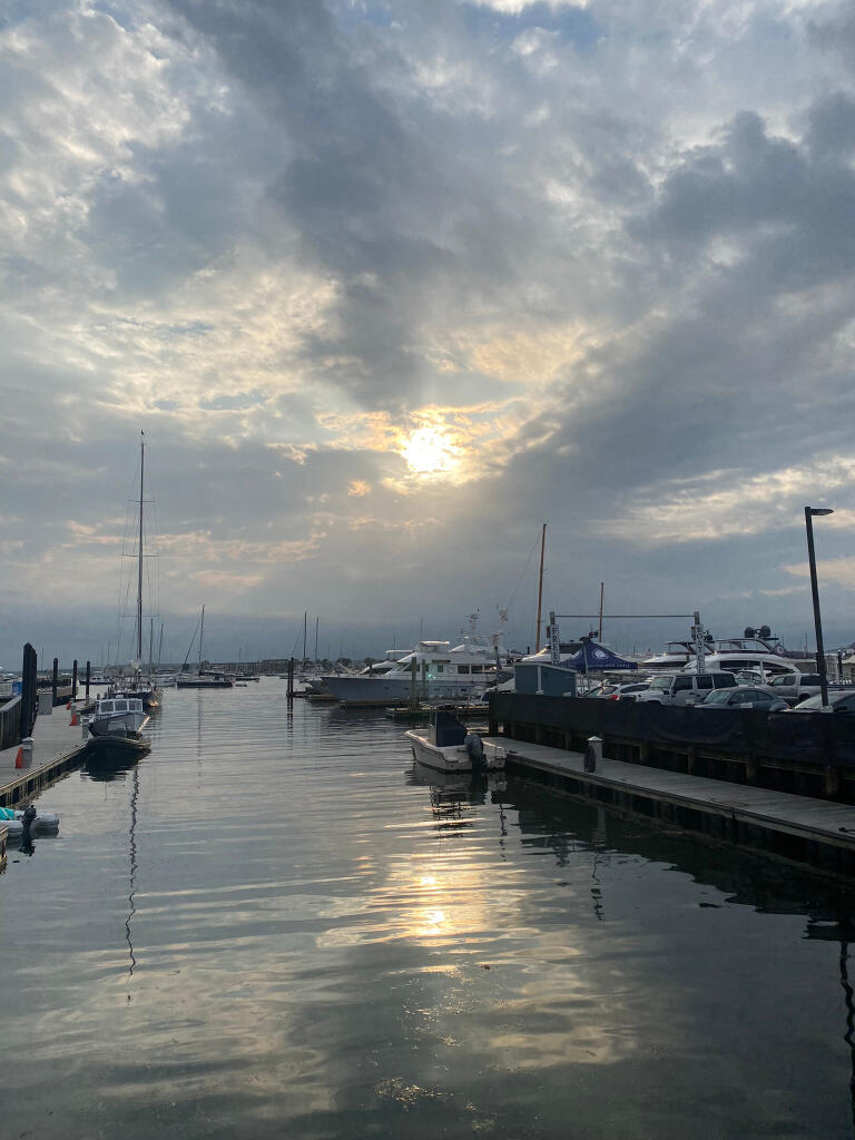 Reflection The sun shining through clouds and reflecting in the water.